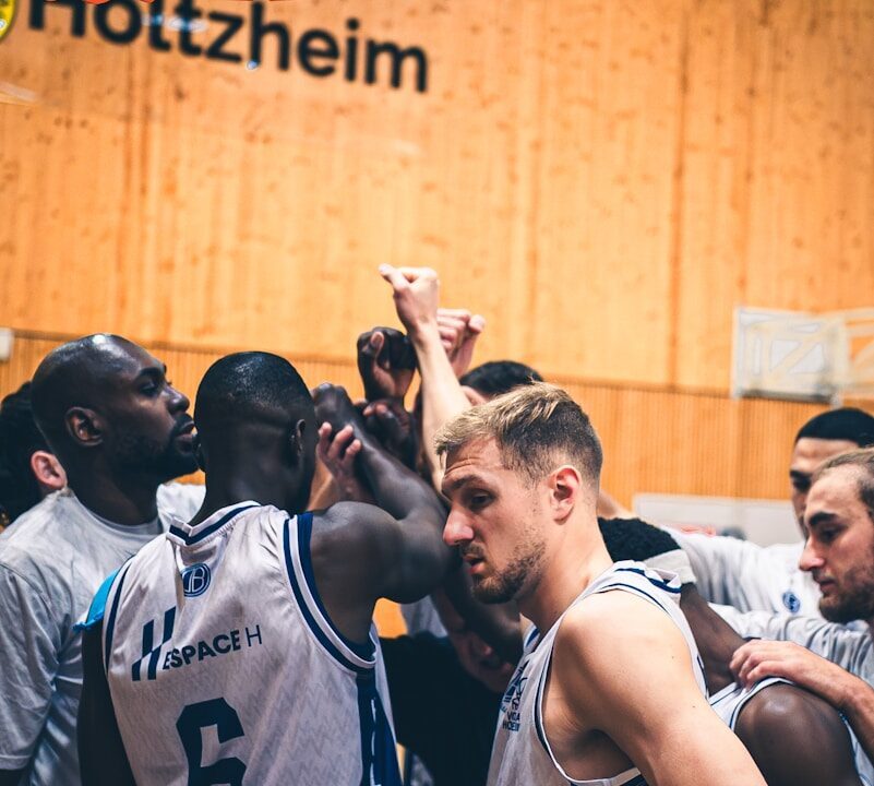 Basketball players huddle together during a game.