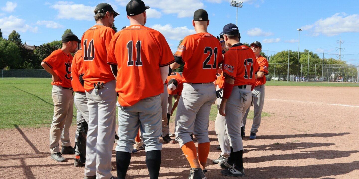 a group of baseball players standing next to each other on a field