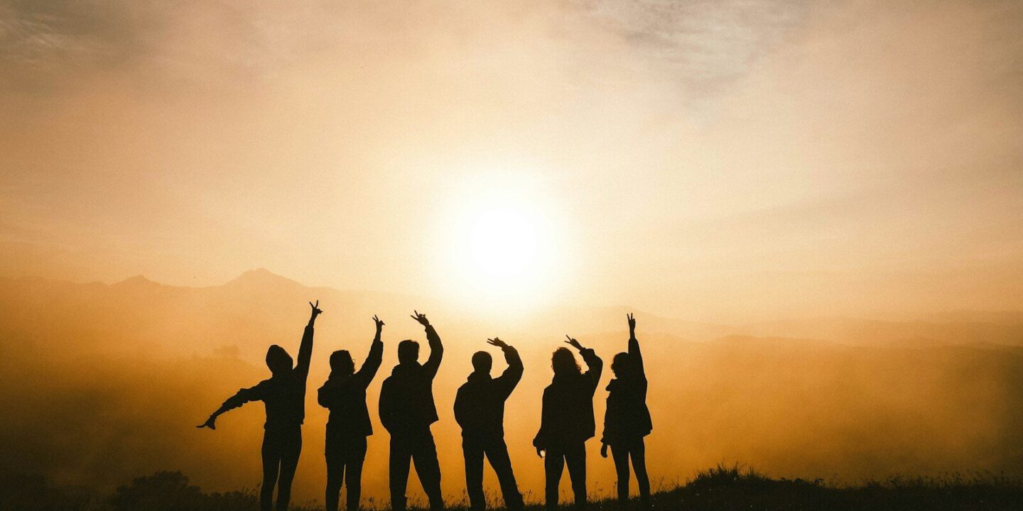 silhouette photo of six persons on top of mountain